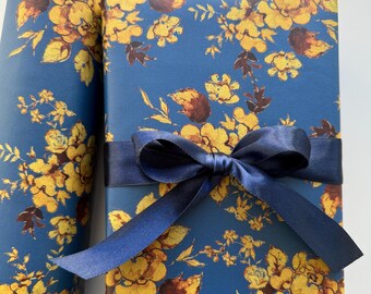 May include: A blue gift wrap with a yellow floral pattern and a navy blue satin ribbon. The gift wrap is perfect for a special occasion.