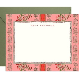 May include: A rectangular stationery card with a cream-coloured centre and a pink border featuring a repeating floral pattern in red and green. The name EMILY RAGSDALE is printed in red at the top centre. The card is paired with a solid olive green envelope.