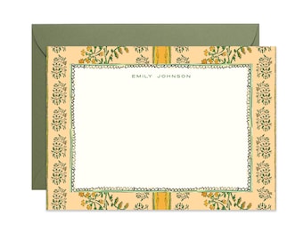 May include: A rectangular stationery card with a cream-colored center and a border featuring a peach background with green and yellow floral patterns. The card displays the name EMILY JOHNSON in dark text and includes a matching olive green envelope.