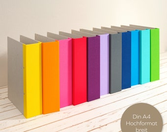 Wide A4 album in portrait format with colored linen spine 2 or 4 folder mechanism as a layflat folder. Radiant colors.