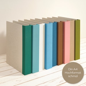 Álbum A4 formato retrato com lombada em linho colorido e mecanismo de dobra dupla como pasta plana. Decorativo para escritório ou sala de estar