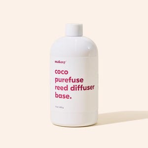 May include: A white bottle of "makesy" coco purefuse reed diffuser base. The bottle has a white cap and the text is in a magenta color. The bottle contains 16 oz / 453 g of product.