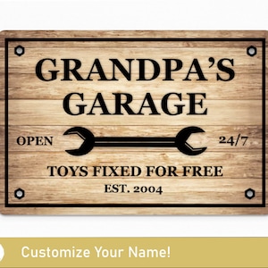 May include: A wooden sign with black text that reads "Grandpa's Garage" with a wrench graphic and the text "Open 24/7 Toys Fixed For Free Est. 2004".