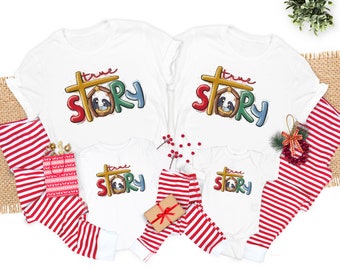 May include: A set of four white t-shirts with red and green stripes, featuring the phrase "true story" with a manger scene illustration. The shirts are available in different sizes for adults and children.