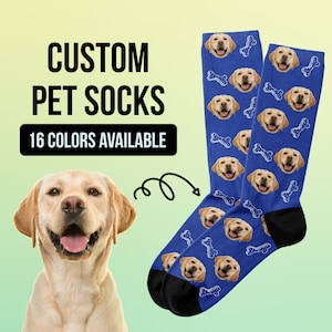 May include: A pair of blue socks with a repeating pattern of a dog's face and bone. The socks are custom made with a photo of a dog. The text "CUSTOM PET SOCKS" and "16 COLORS AVAILABLE" is displayed on the image.