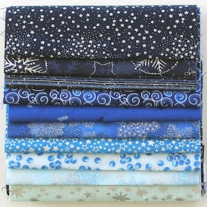 Könnte beinhalten: Ein Stapel aus zehn blauen und weißen Stoffresten mit verschiedenen Mustern, darunter Sterne, Wirbel und Schneeflocken.