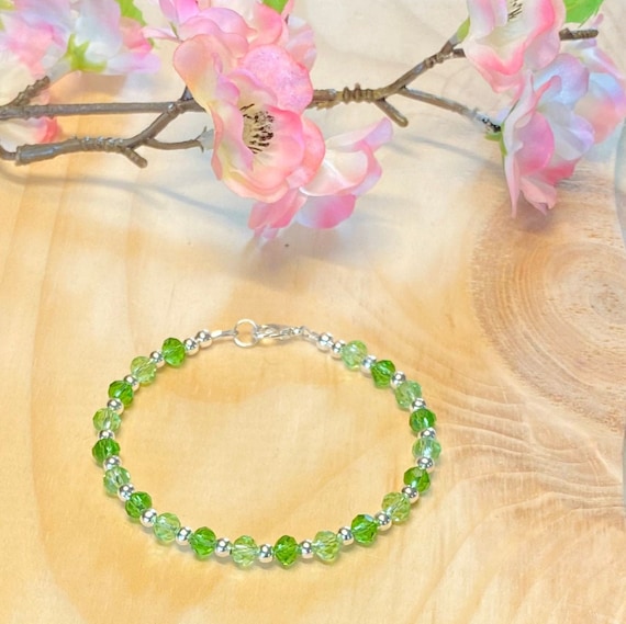 Peridot bracelet with 4 strands and selling silver and crystal clasp.