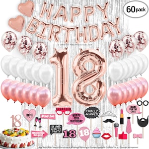 May include: A set of 60 rose gold party decorations for an 18th birthday. The set includes balloons, confetti, and photo booth props. The balloons include two large numbers 18, a happy birthday banner, and smaller balloons in rose gold and white. The confetti is rose gold and the photo booth props include a mustache, a crown, a microphone, and a lipstick.