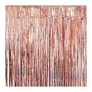 May include: A rose gold foil fringe curtain backdrop for parties and events. The curtain is made of thin strips of foil that hang down from a horizontal bar. The foil is shiny and reflective, and the curtain is a beautiful way to add a touch of glamour to any celebration.