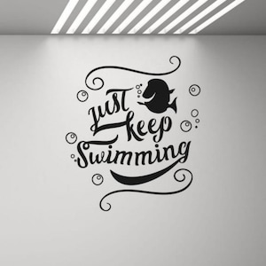 May include: Black and white wall decal with the text "Just Keep Swimming" and a stylized fish illustration.