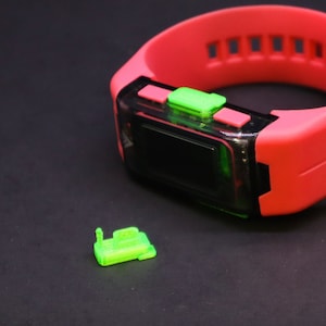 May include: A red and green digital wristwatch with a black display. The watch has a bright red silicone band and green buttons.