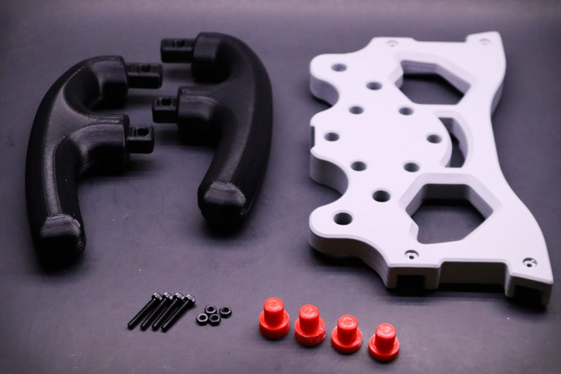 May include: A set of 3D printed parts for a gaming controller. The set includes two black handles, a white base plate, four red buttons, five black screws, and three silver nuts.