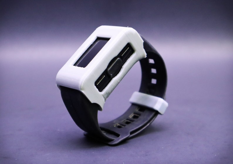 May include: A white and black wristwatch with a digital display and a black rubber band.