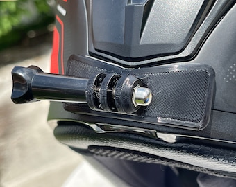May include: A black 3D-printed camera mount attached to the front of a matte black motorcycle helmet. The mount features a horizontal rectangular base with a three-prong extension arm secured by a silver metal bolt, designed for action cameras.
