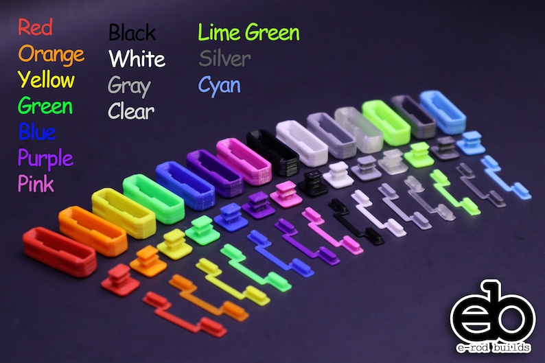 May include: Assortment of 3D printed keycaps in various colors, including red, orange, yellow, green, blue, purple, pink, black, white, gray, lime green, silver, cyan, and clear. The keycaps are arranged in rows by color, with the largest keycaps at the top and the smallest at the bottom.