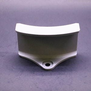 May include: White plastic curved bracket with a hole in the bottom.