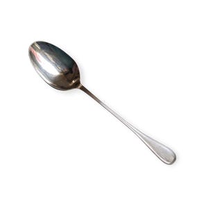 May include: A silver spoon with a rounded bowl and a long, slender handle. The spoon is made of a shiny, reflective metal, likely stainless steel. The handle has a slight curve and a simple, elegant design. The spoon is isolated on a white background.