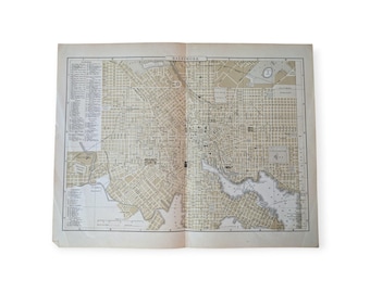May include: An open vintage map of Baltimore, Maryland, with a detailed grid of streets and labeled landmarks. The map is printed on aged paper, showing signs of wear and tear, and is open to display the full city layout.
