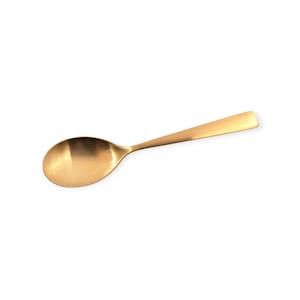 May include: A single, gold-colored spoon with a rounded bowl and a long, flat handle. The spoon is made of a shiny metal and is set against a white background. The spoon is designed for serving or eating.