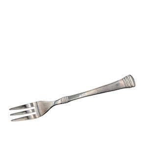 May include: A silver fork with three tines, angled slightly to the left. The handle has a decorative design near the end. The fork is made of a shiny metal and is set against a white background. This is a piece of silverware.