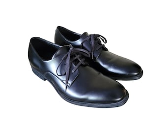 May include: A pair of black leather lace-up shoes. The shoes have a polished finish and a classic design.