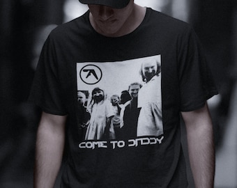 May include: A black t-shirt with a white graphic print of a band, the band's logo, and the text "COME TO DADDY".