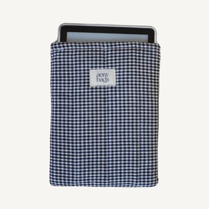 May include: A black and white gingham tablet sleeve with the text "aeny bags" on a white tag.