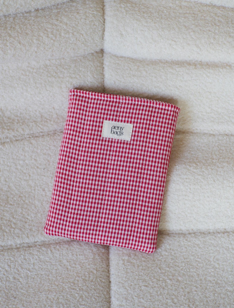 May include: Red and white gingham fabric pouch with a white label that says "aery bags".