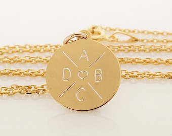 May include: Gold necklace with a round pendant featuring a heart and the letters A, D, B, and C.