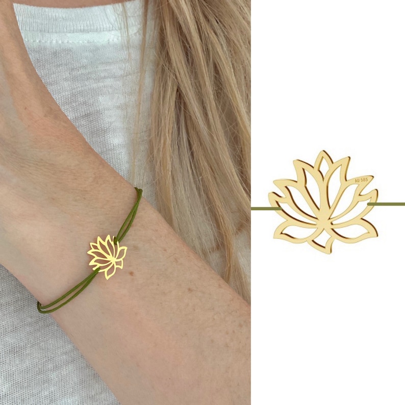 May include: A gold-colored lotus flower charm bracelet with a green cord. The lotus flower is the focal point, and the bracelet is worn on a wrist. The bracelet is a delicate piece of jewelry.