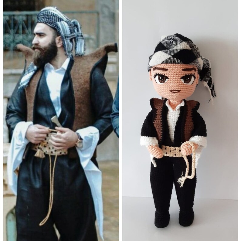 May include: A crocheted doll wearing a black and white patterned hat, a brown vest, and black pants with a white belt. The doll is holding a rope in its right hand.
