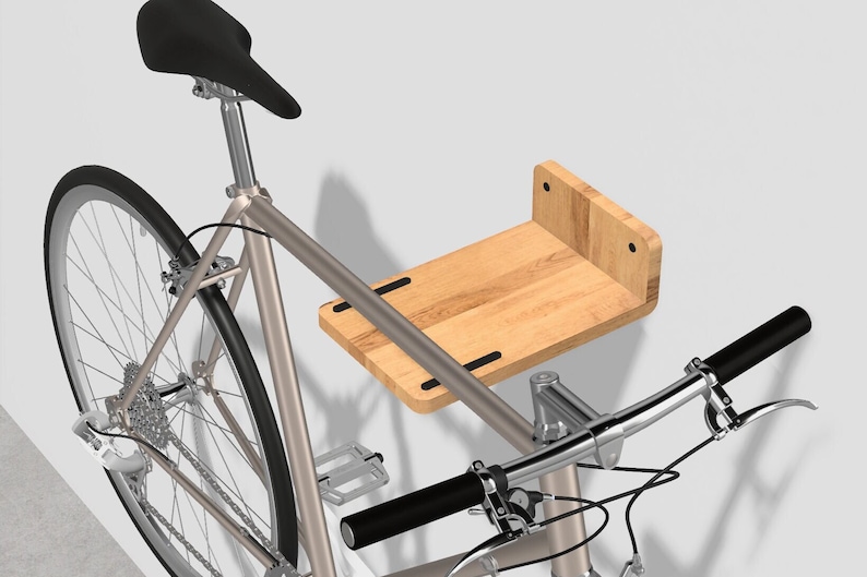 Oak wood wall mount with rubber grip strips and bike resting on it