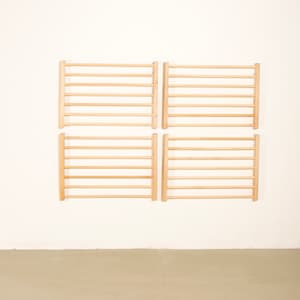 May include: Four wooden wall-mounted ladder-style climbing frames, each with 8 rungs, arranged in a 2x2 grid pattern against a white wall.