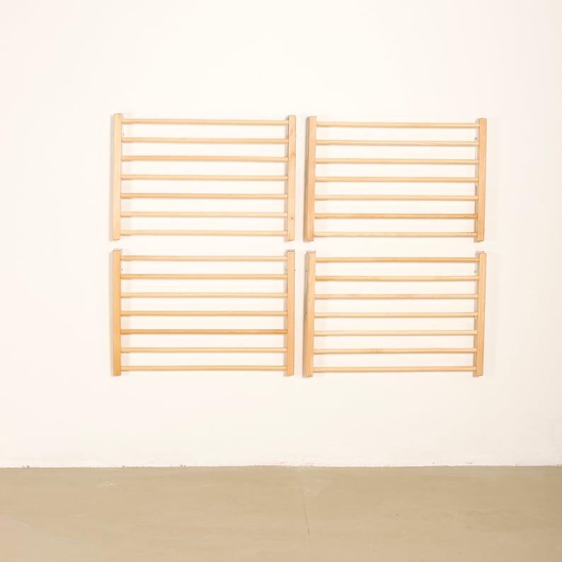 May include: Four wooden wall-mounted ladder-style climbing frames, each with 8 rungs, arranged in a 2x2 grid pattern against a white wall.