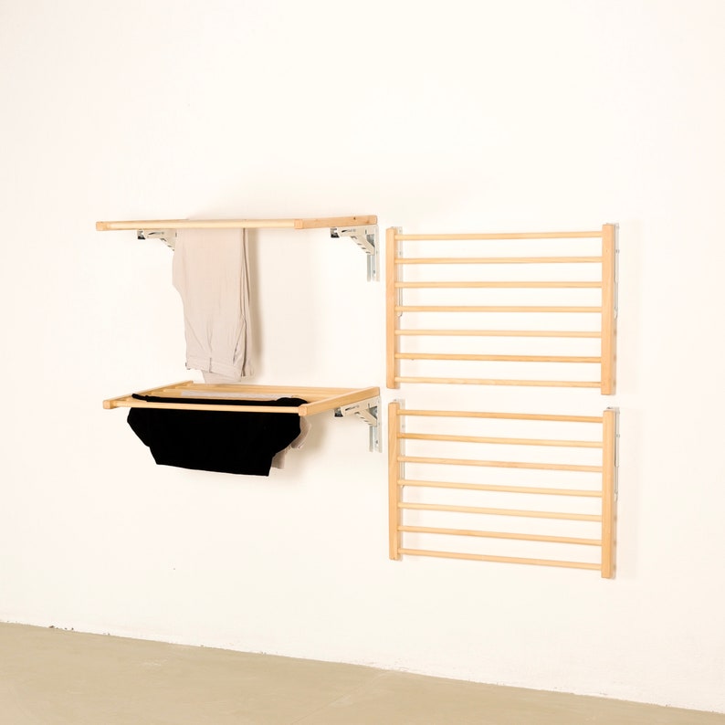 May include: A set of four wooden wall-mounted drying racks. Two of the racks are horizontal and two are vertical. The racks are made of natural wood and have a light brown finish. The racks are ideal for drying clothes or towels.