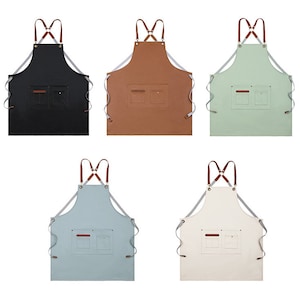 May include: Five different coloured aprons with adjustable straps and two pockets. The aprons are black, brown, green, light blue, and white.