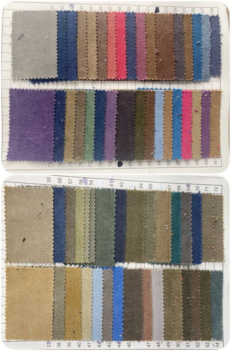 May include: A fabric swatch sample book featuring a grid of rectangular textile pieces in various colors including gray, blue, pink, purple, green, brown, and tan. Each swatch is numbered with printed digits ranging from 37 to 108.