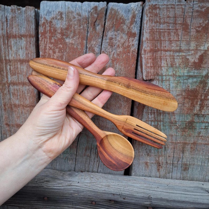 May include: A set of three ceramic mugs with a speckled, matte finish. The mugs are in shades of cream, light gray, and dark gray. Each mug has a simple, minimalist design, perfect for coffee or tea.