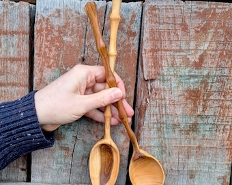 A set of carved wooden serving spoons made from plum wood Hand-carved wooden spoons Decorative wooden spoon with a wavy handle