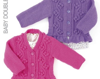 May include: Two knitted baby cardigans with a button-up front and a ruffled hem. One cardigan is pink and the other is purple.