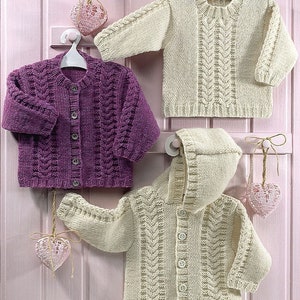May include: Three knitted baby sweaters, one purple, one cream, and one cream with a hood. The sweaters have a cable knit pattern and button closures.
