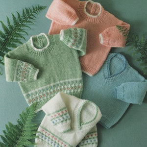 May include: Four knitted jumpers in different colours: pink, green, white and blue. Each jumper has a white trim around the neck and a patterned design on the sleeves and bottom.