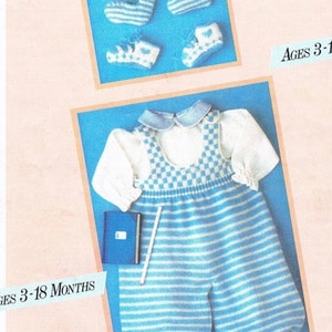 May include: A baby outfit set featuring a blue and white striped romper with a checkered bib, a white collared shirt, and matching blue and white striped booties. A small blue notebook and a white pencil are also included. The text on the image reads "AGES 3-18 MONTHS."