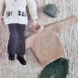 May include: Knitting pattern for a doll outfit, featuring a white cardigan with black accents, a beige sweater, and green pants. The pattern includes a white hat with black accents.