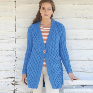 May include: A long, blue cardigan with a cable knit pattern and a single button closure. The cardigan is worn over a striped shirt and white pants.