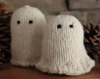 May include: Two small white knitted ghost ornaments with black button eyes.