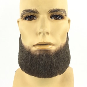 May include: A brown fake beard on a mannequin head. The beard is thick and full, covering the chin and neck.