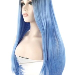 May include: A long, straight wig with a black to blue ombre effect. The wig is styled on a mannequin head, showcasing the vibrant blue color that transitions from the dark roots. The hair is sleek and appears to be synthetic.