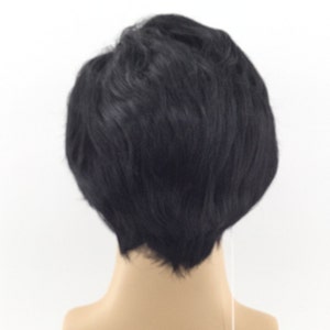 May include: A black wig with short, choppy layers. The wig is styled in a casual, modern look.