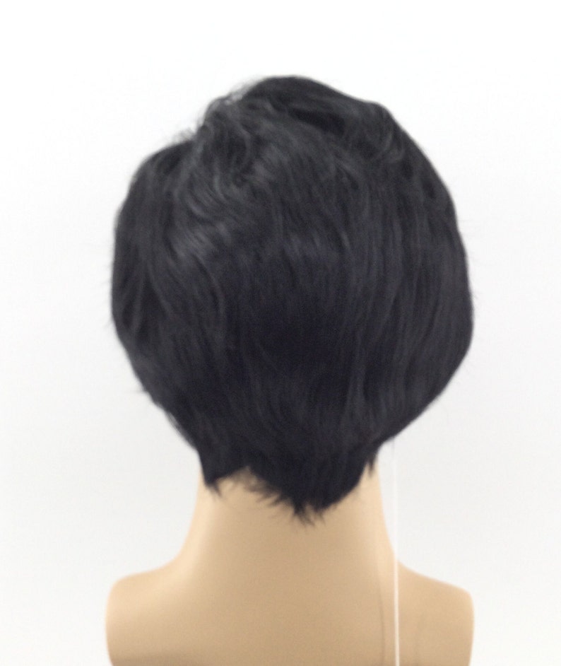 May include: A black wig with short, choppy layers. The wig is styled in a casual, modern look.